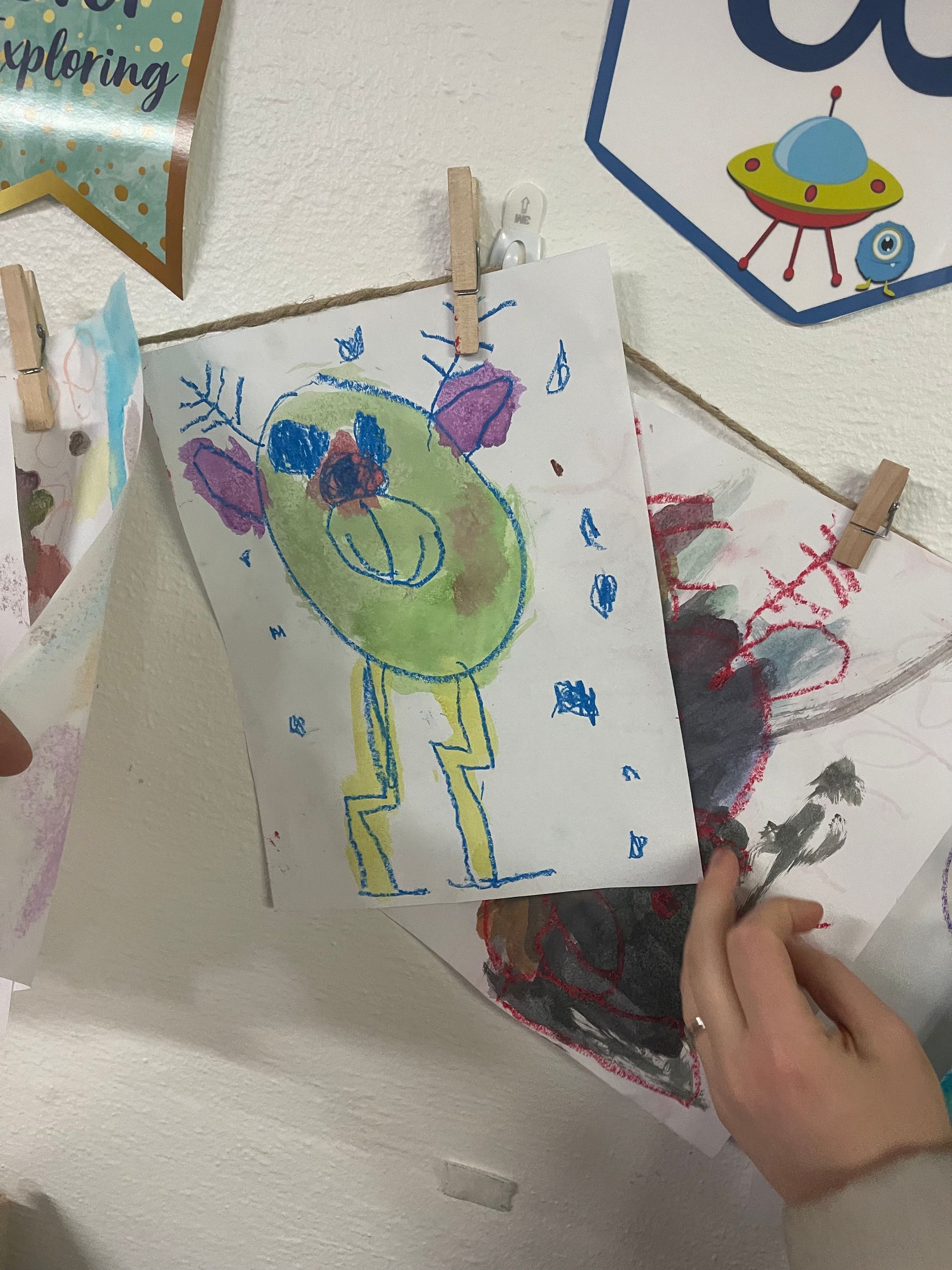 A child's drawing that looks kind of like a green monster